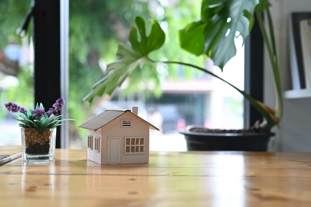 House model on wooden table. Real estate mortgage concept.